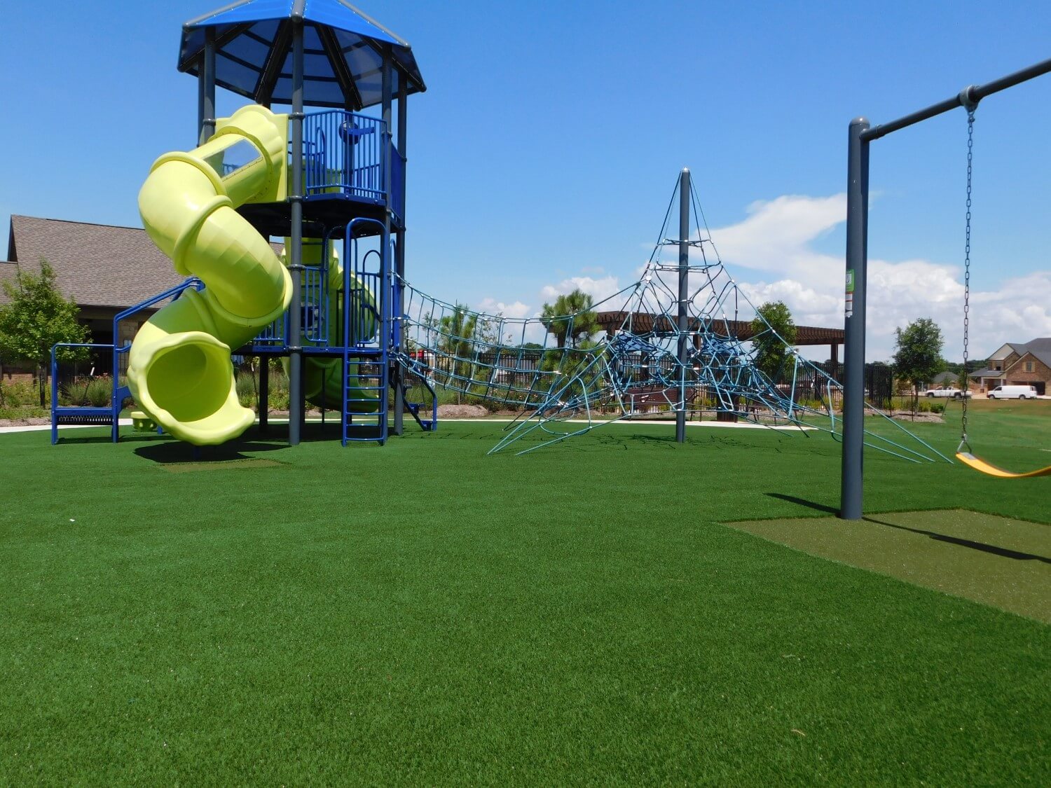Commercial artificial grass playground with yellow slide