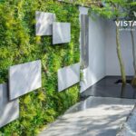 Residential outdoor wall accented with artificial living wall panels