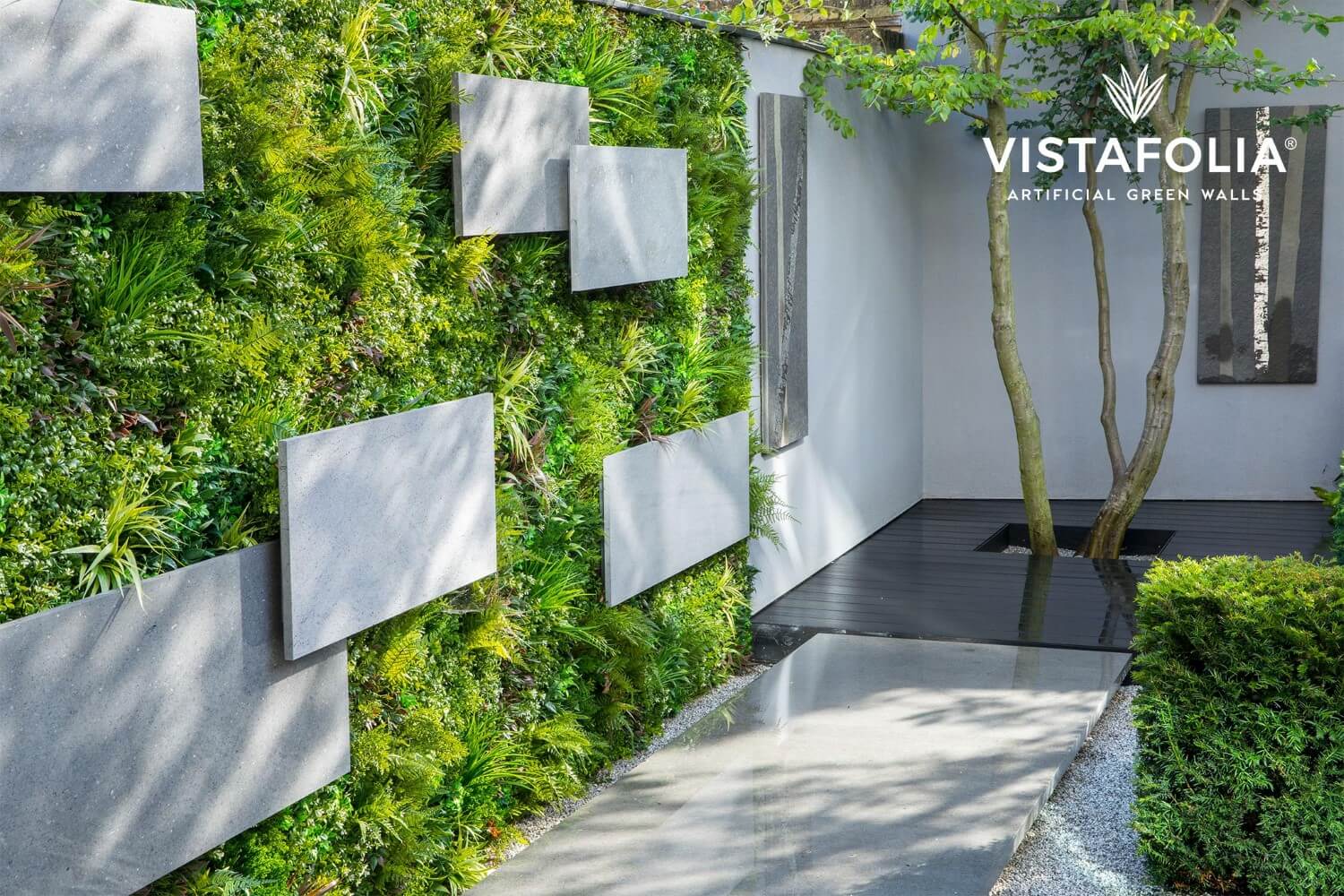 Residential outdoor wall accented with artificial living wall panels