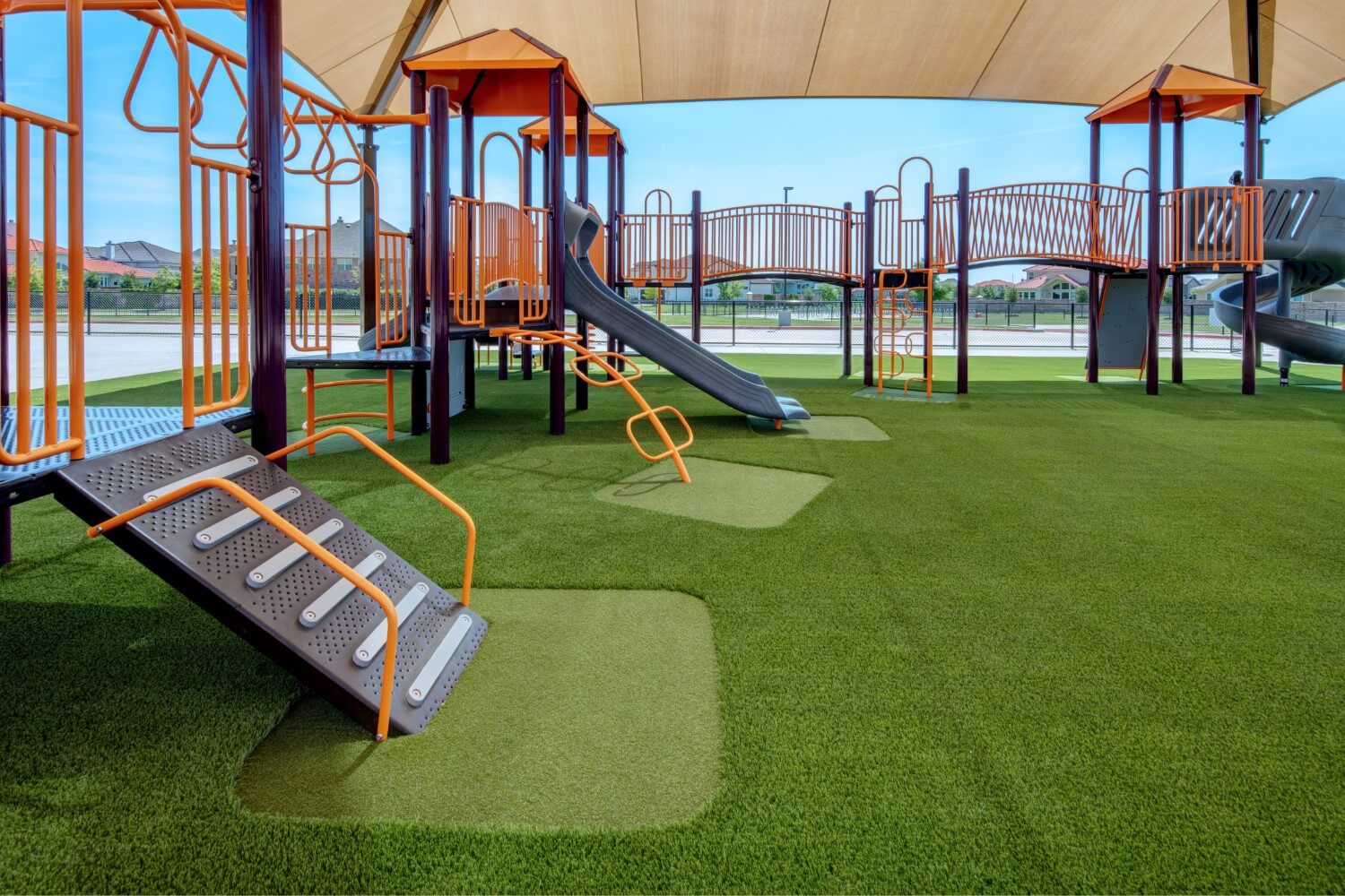 Multi colored jungle gym equipment installed on SYNLawn Artificial Grass