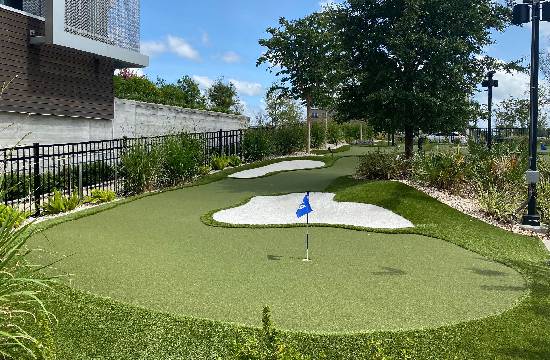 Artificial golf grass installation with sand trap