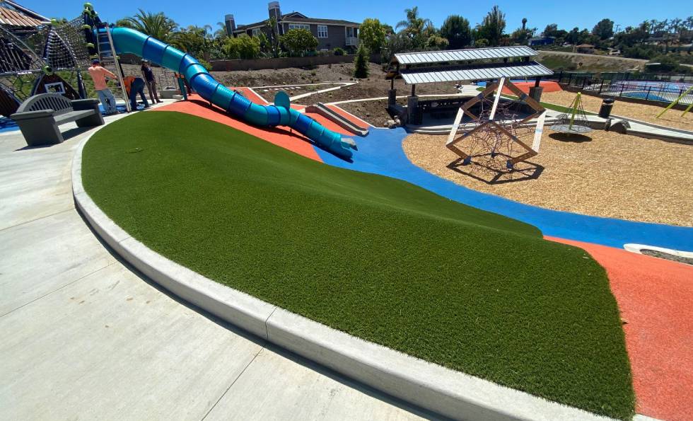 Slide and play area view of the Olympus Park with artificial grass provided by SYNLawn
