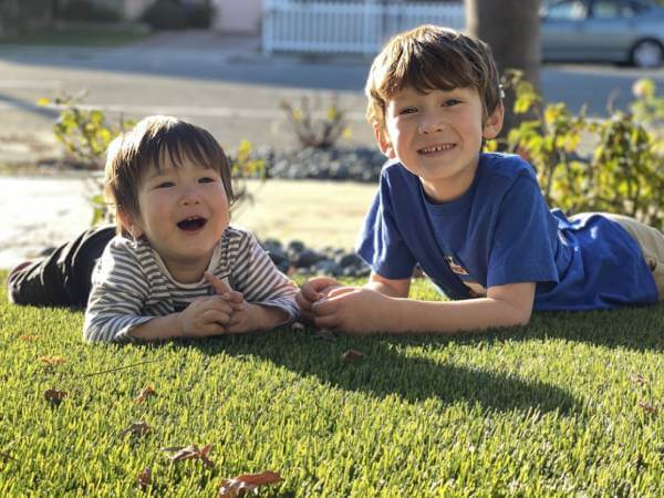 Kids playing on eco friendly artificial grass