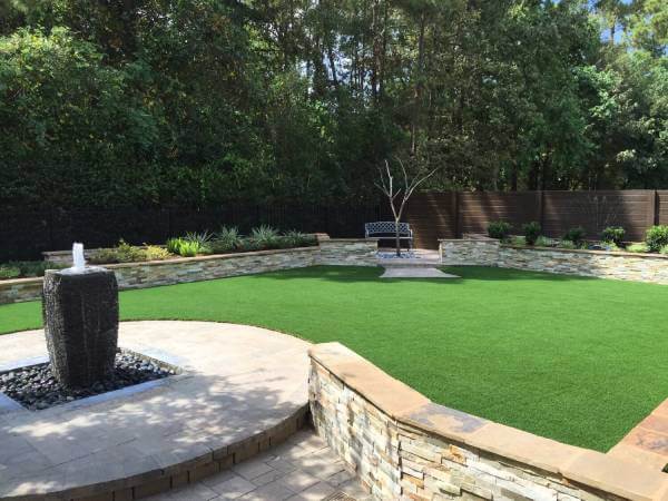 residential backyard with artificial grass installed