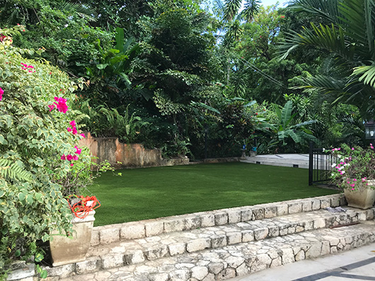 Artificial grass gardening area with stone steps