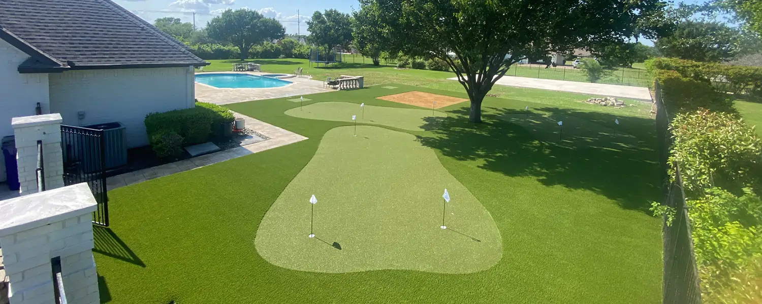 Backyard pool area putting green installed by SYNLawn